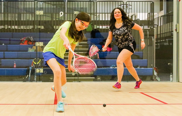 Mother and daughter playing squash